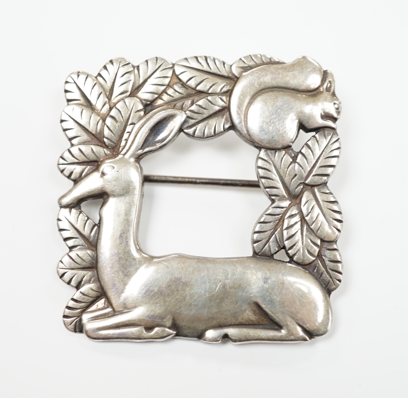 A Georg Jensen sterling kneeling deer and squirrel square brooch, design no. 318, 38mm.